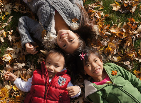 Pure Dental Family Kids laying in leaves